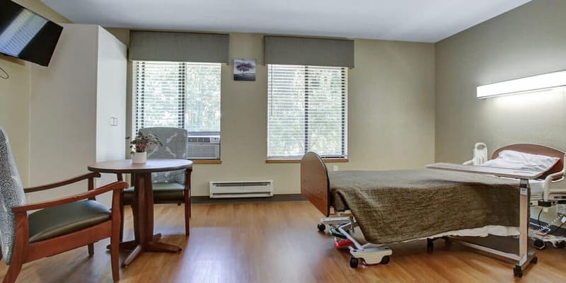 Private resident room with bed and seating area