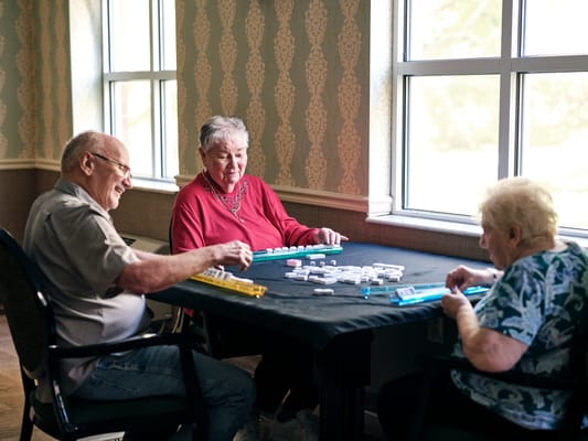 Residents playing a game together at a table