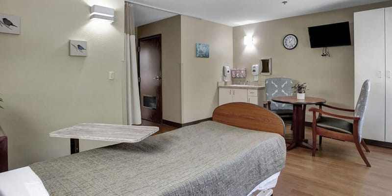 Private room with a bed and dining table