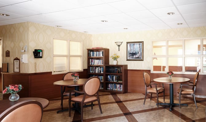 Bright common area with tables and bookshelves
