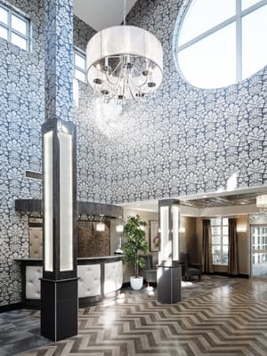 Bright and elegant lobby area with floral wallpaper