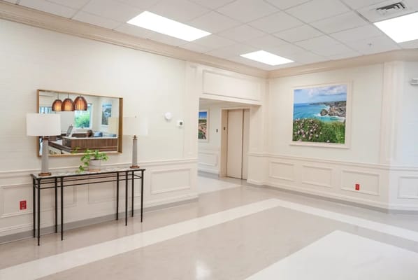 Bright interior lobby area with seating and wall art