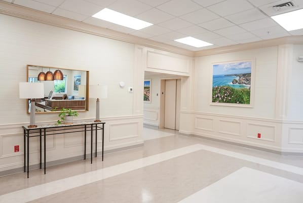 Bright interior lobby area with seating and wall art