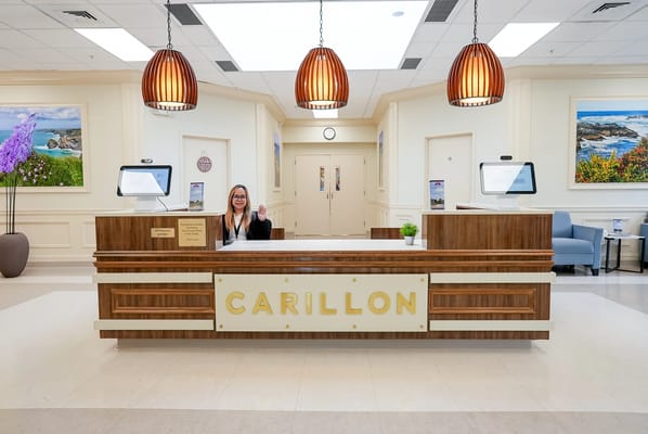 Reception area with staff member welcoming visitors