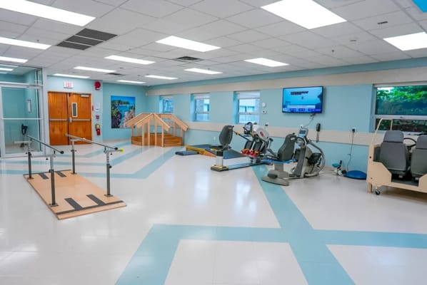 Physical therapy room with equipment for rehabilitation