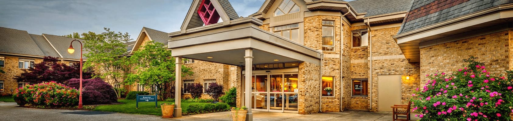 Exterior view of a senior living facility with landscaping