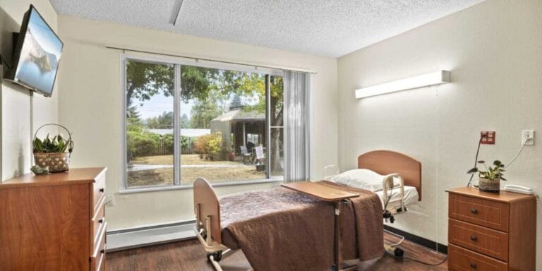 Bright resident room with a bed and window view