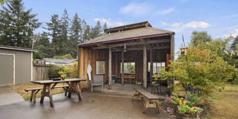 Outdoor covered space with picnic tables and plants