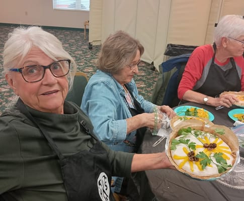 Residents participating in a cooking activity with food