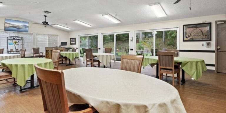 Dining area with tables and chairs set for meals