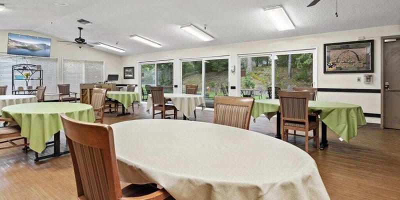 Dining area with tables and chairs set for meals