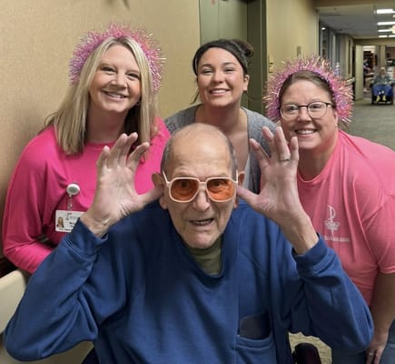 Residents and staff celebrating with silly poses and decorations