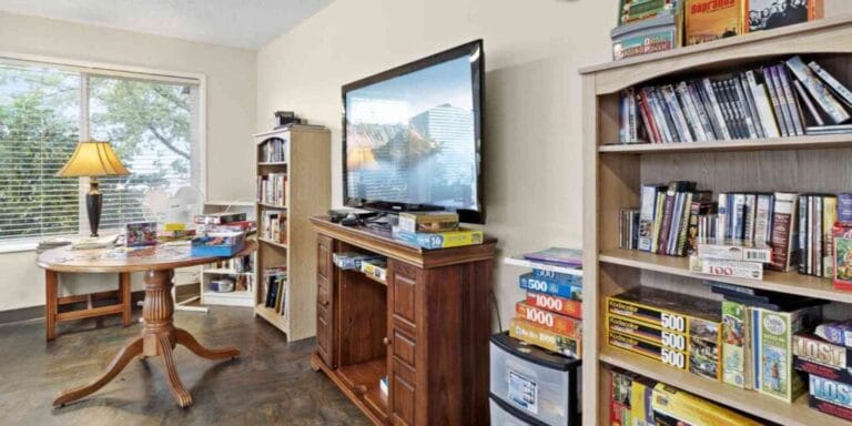 Cozy common area with bookshelves and a table