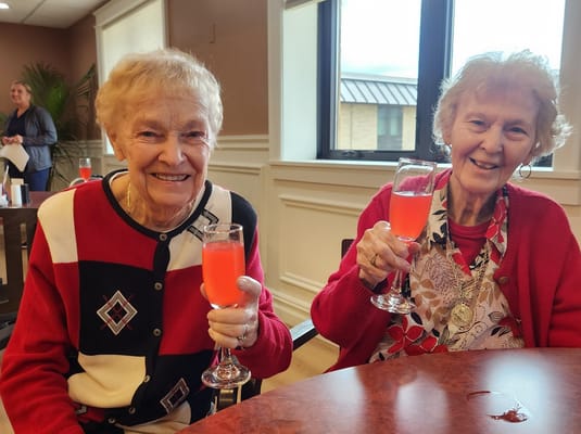 Two residents enjoying drinks and celebrating