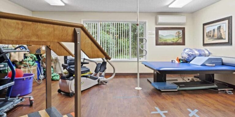 Rehabilitation room with exercise equipment and therapy tools
