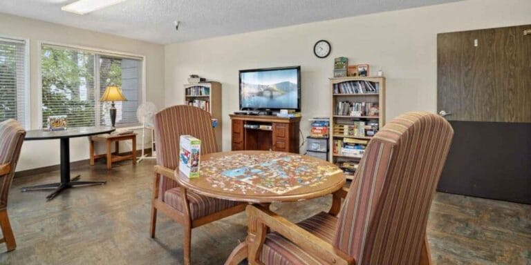 Bright common area with tables and a puzzle