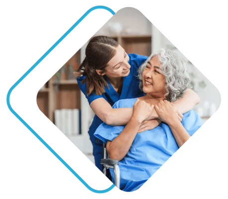 Staff assisting a smiling resident in an interior setting