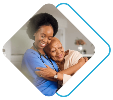 A caregiver embraces a resident warmly