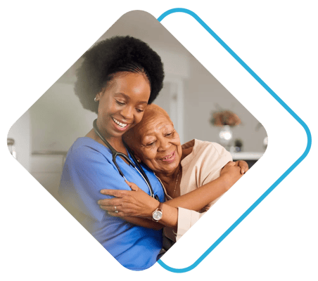 A caregiver embraces a resident warmly