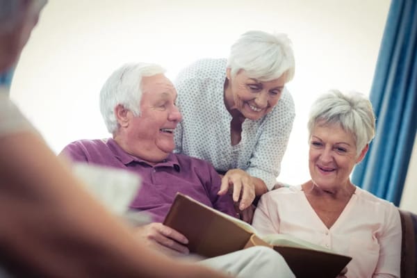 Seniors reading together in a cozy interior setting
