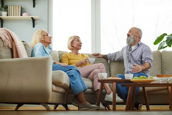 Seniors enjoying conversation in a cozy living room