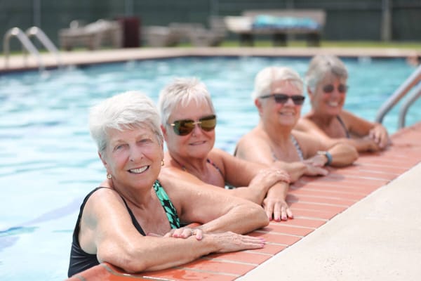 Residents enjoying time by the pool on a warm day