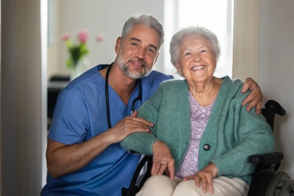 Smiling nurse with a resident in a bright room