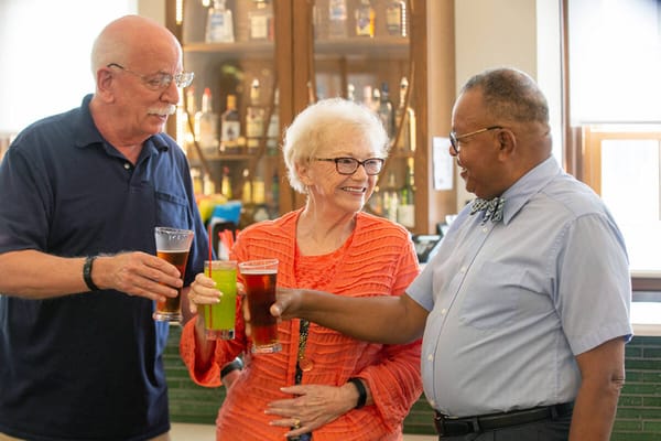 Residents toasting with drinks in a social setting