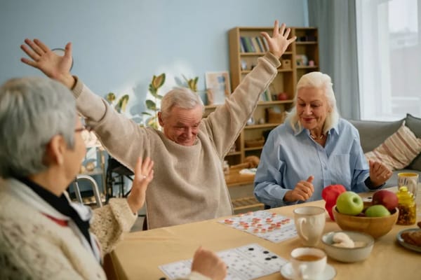 Residents playing bingo with excitement in a vibrant common area