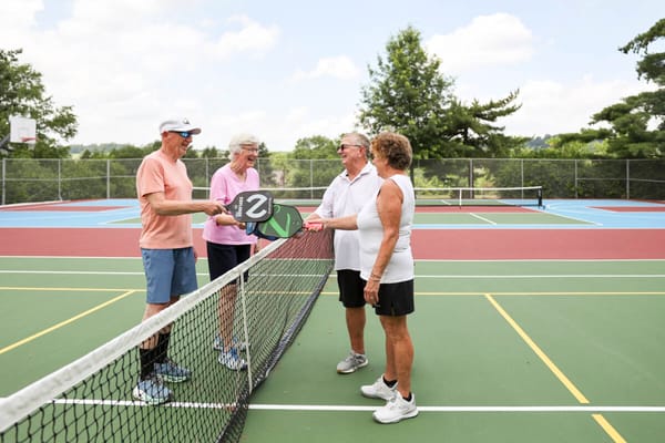 Residents enjoying a friendly game of tennis outdoors