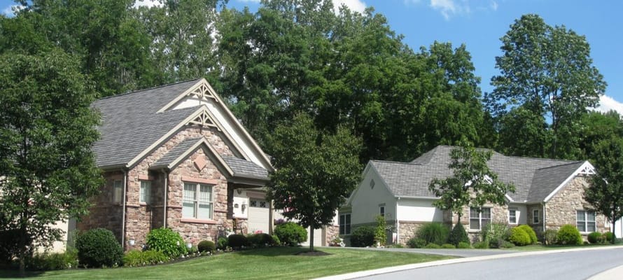 Exterior view of multi-unit residential buildings surrounded by trees