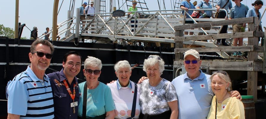 Residents and staff posing together outdoors
