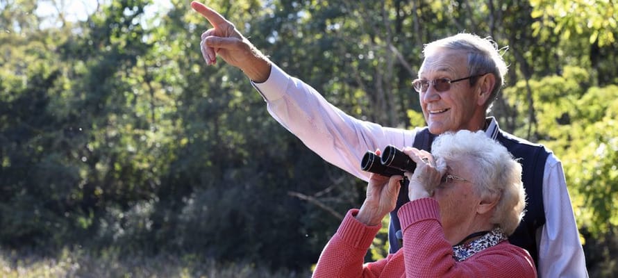 Two residents enjoying binoculars outdoors