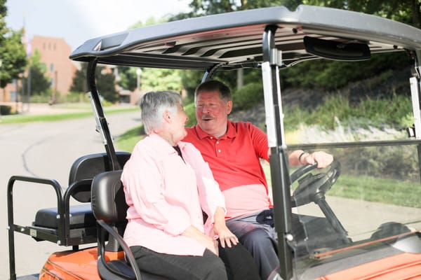 Residents enjoying a ride in a facility vehicle