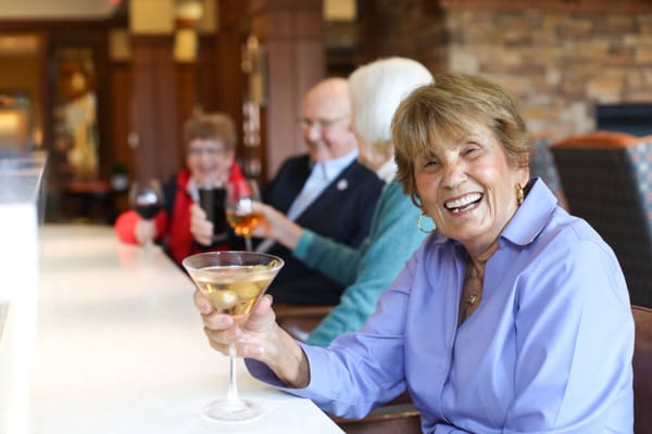 Residents enjoying drinks in a lively common area