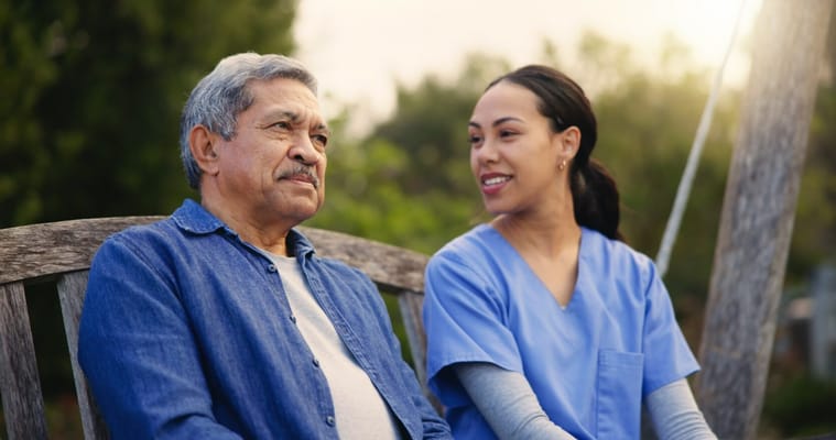 A caregiver talking with a resident outdoors
