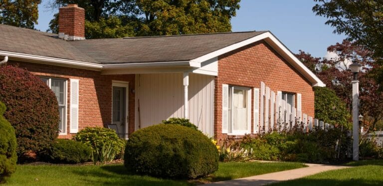 Exterior view of a senior living facility with landscaping