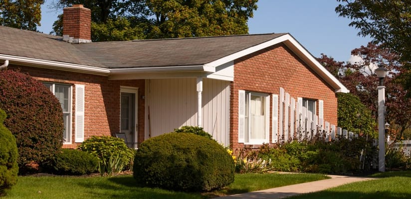 Exterior view of a senior living facility with landscaping