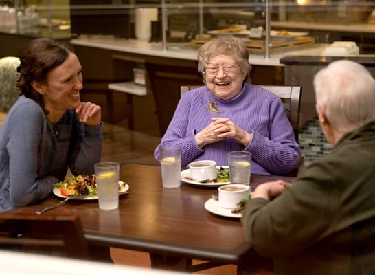 Residents enjoying a meal together in the dining area