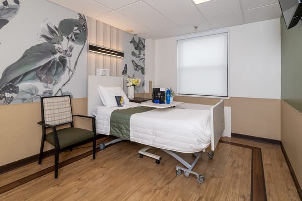 A cozy private resident room with floral decor