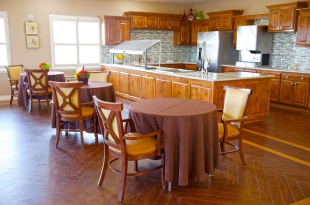 Bright dining area with wooden cabinets and tables