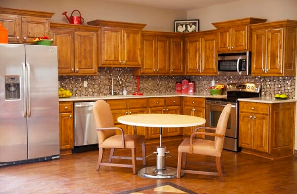 Modern kitchen with wooden cabinets and a round table
