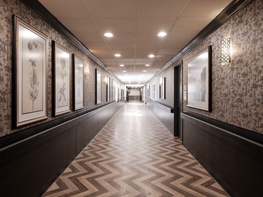 Well-lit interior hallway with artwork