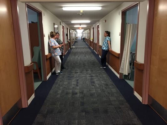Healthcare staff engaging in a hallway setting