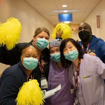 Staff members celebrating in a hallway