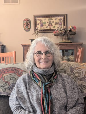 A resident smiling in a cozy living area