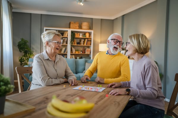 Seniors enjoying a fun game together at a table