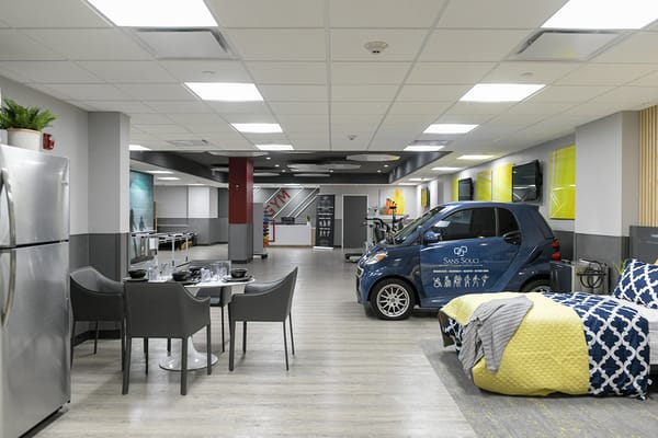 Bright interior common area with dining setup and vehicle