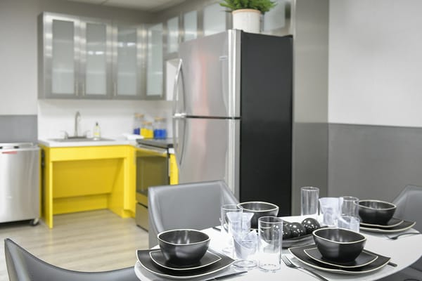 Modern kitchen with dining table and appliances
