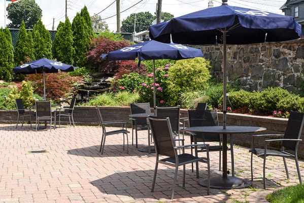 Outdoor seating area with umbrellas and plants